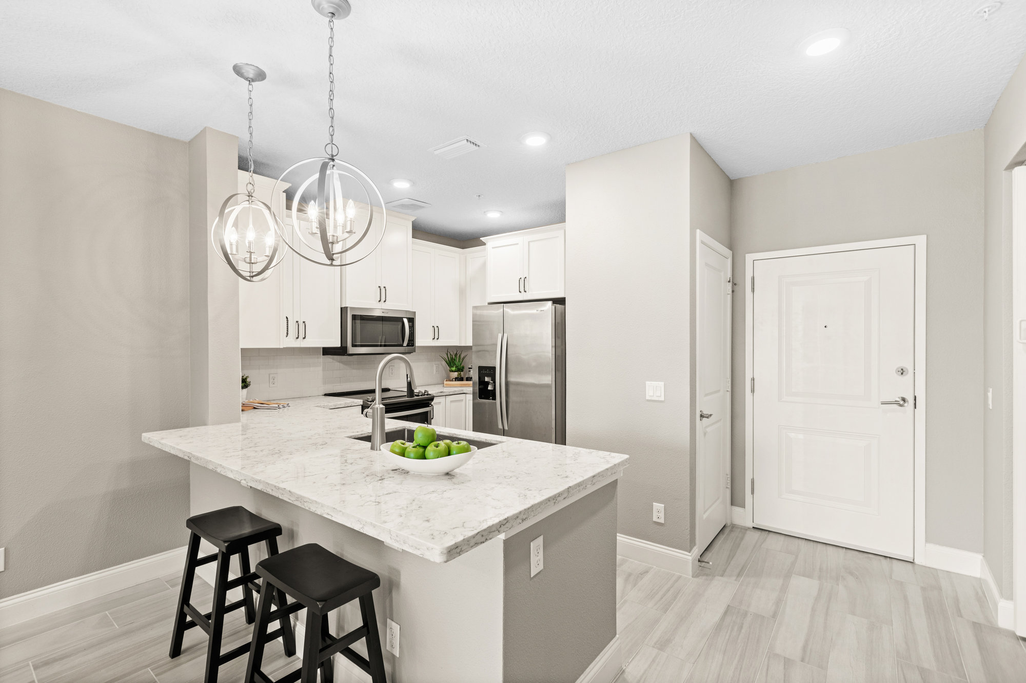 inside front entrance with kitchen and wood plank floors